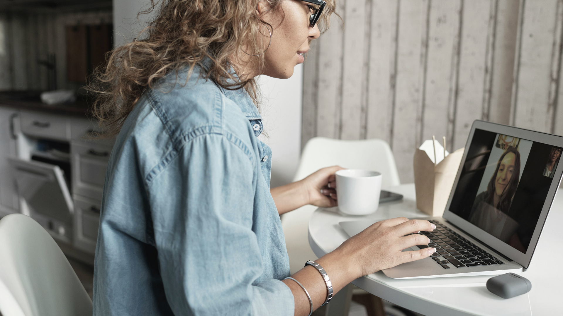 Photo of woman taking a video call on a laptop