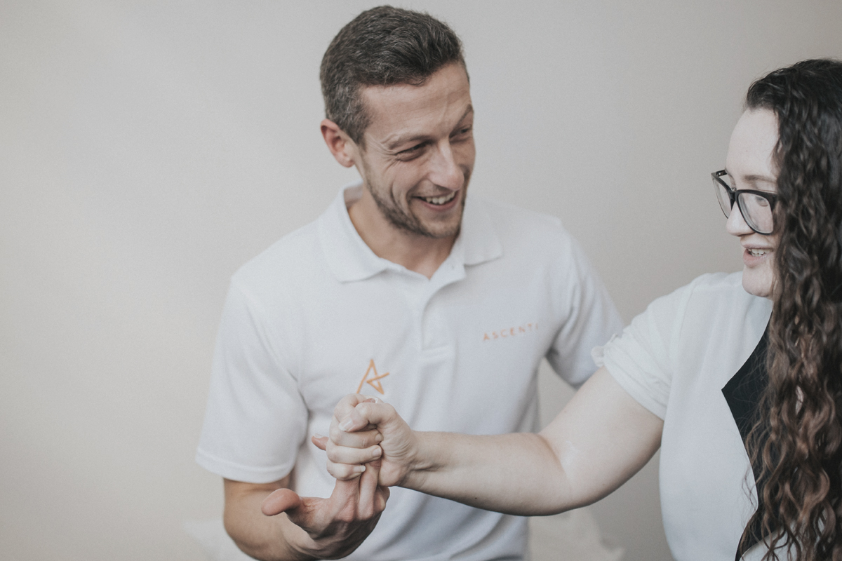 Photo of Ascenti Physiotherapist conducting an elbow exercise with a patient