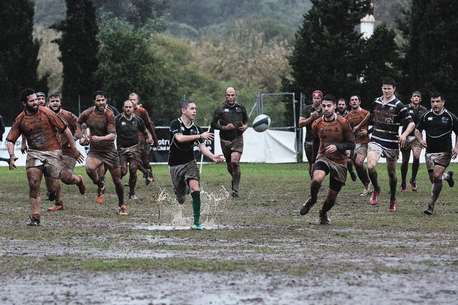 Players in rugby match passing the ball