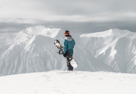 snowboarder staring at the mountains
